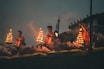 people sitting on brown wooden bench during night time
