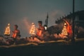 people sitting on brown wooden bench during night time