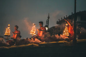 people sitting on brown wooden bench during night time