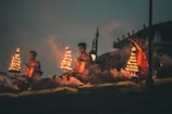 people sitting on brown wooden bench during night time