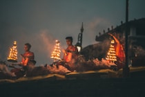 people sitting on brown wooden bench during night time