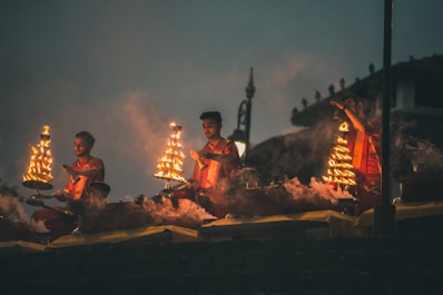 people sitting on brown wooden bench during night time