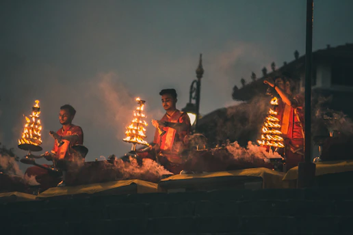 A serene scene of a priest performing a traditional Vedic ritual with oil lamps.