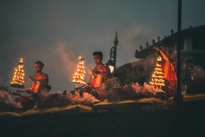 people sitting on brown wooden bench during night time