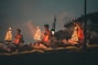 people sitting on brown wooden bench during night time