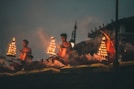 people sitting on brown wooden bench during night time