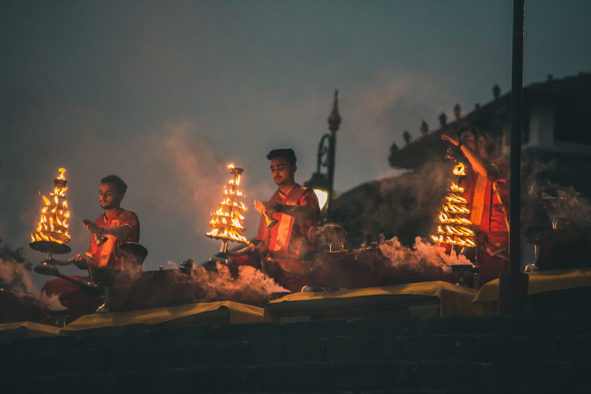 Ganga aarti with flaming tiered lamps at night in Varanasi