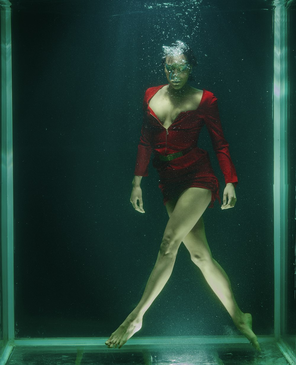 woman in red long sleeve shirt and black panty under water