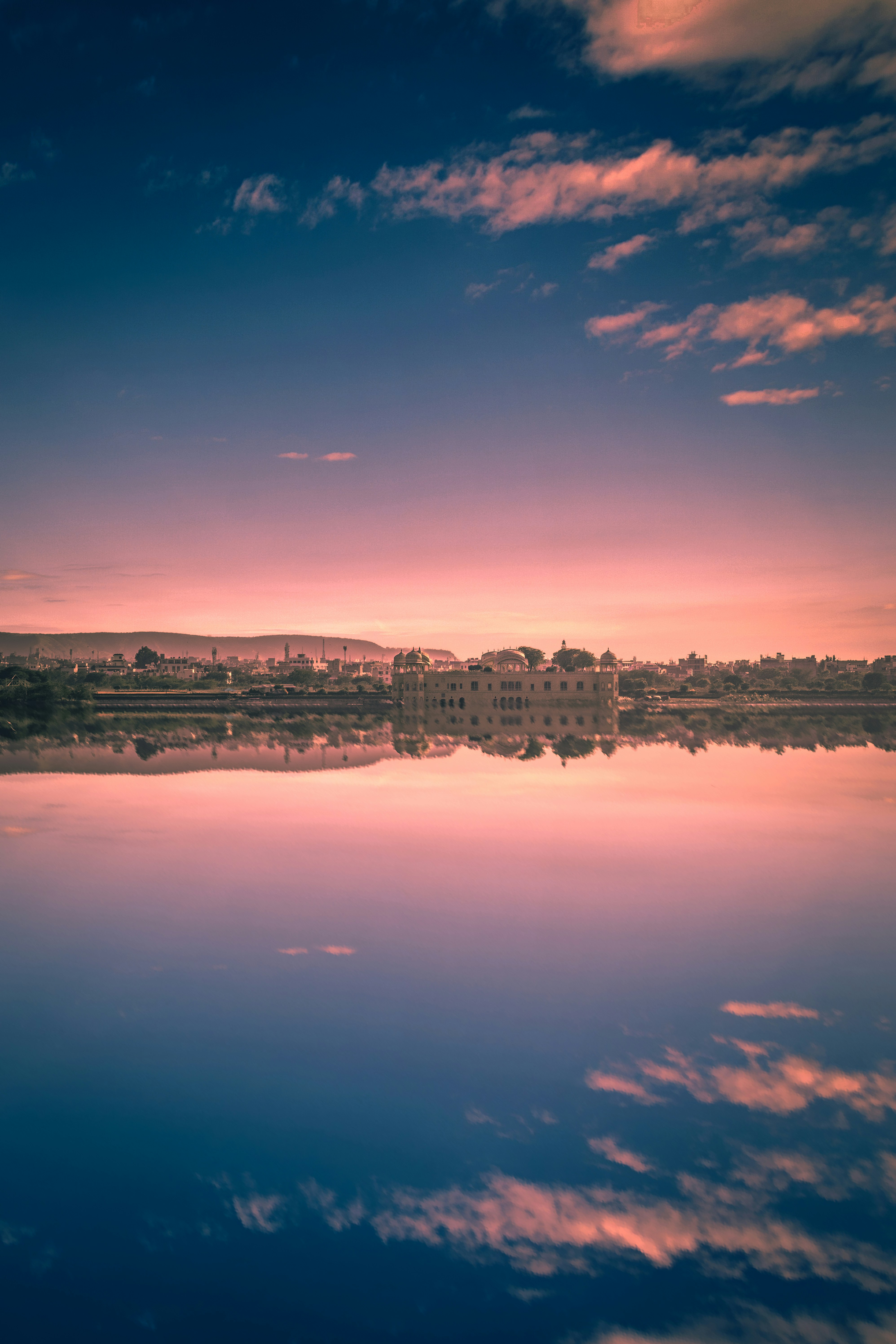 city skyline near body of water during night time