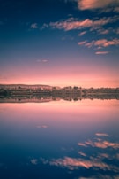 city skyline near body of water during night time