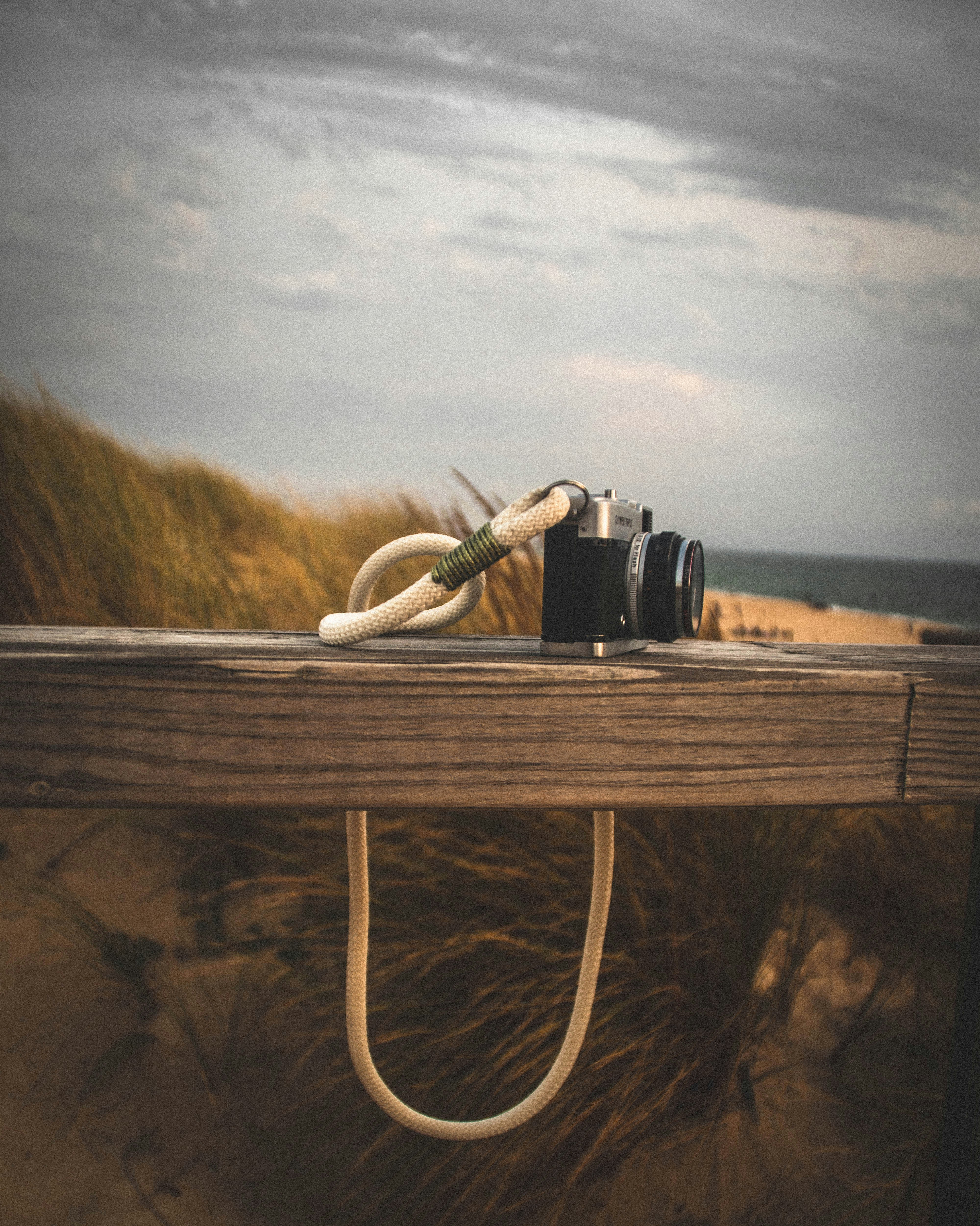 black dslr camera on brown wooden table