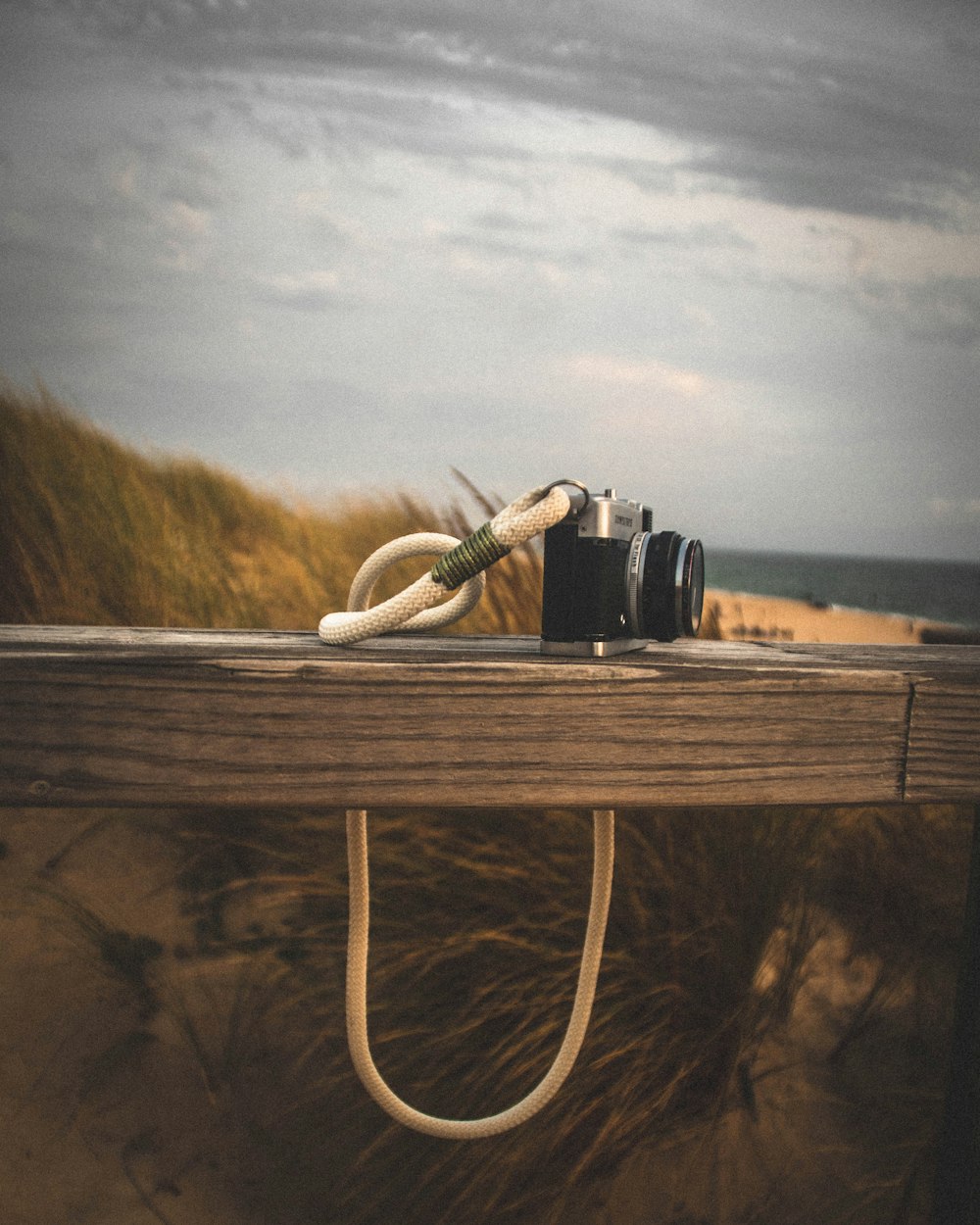 black dslr camera on brown wooden table