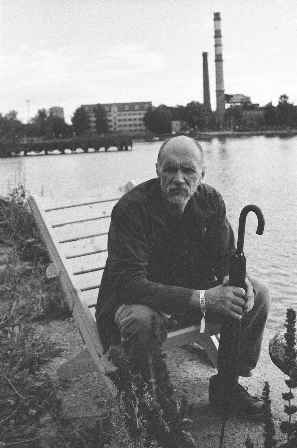 man in black long sleeve shirt sitting on bench