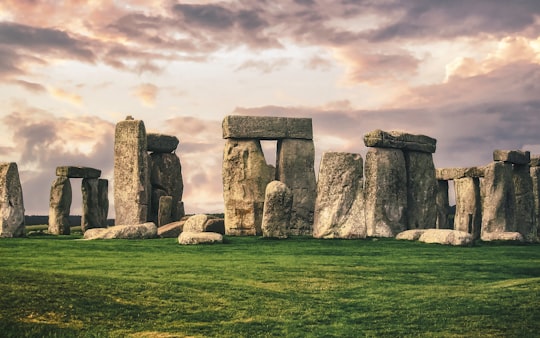 gray rock formation on green grass field under gray cloudy sky in Stonehenge United Kingdom
