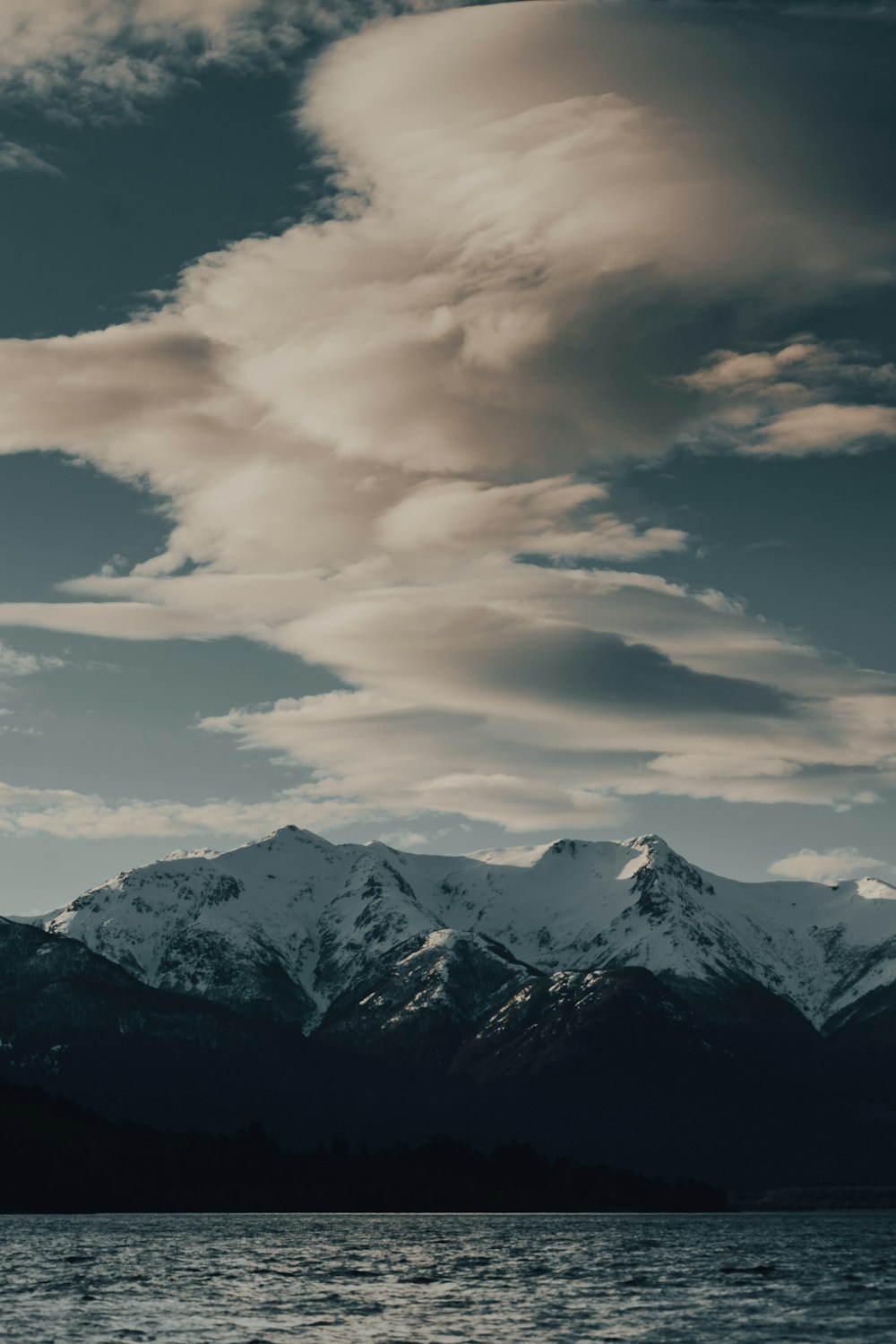 snow covered mountain under cloudy sky during daytime