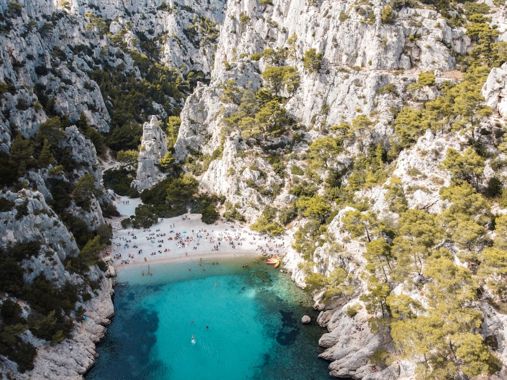 aerial view of body of water between gray rocky mountain during daytime