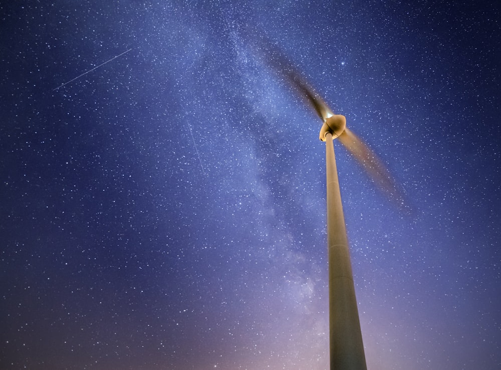 white and black wind turbine under blue sky