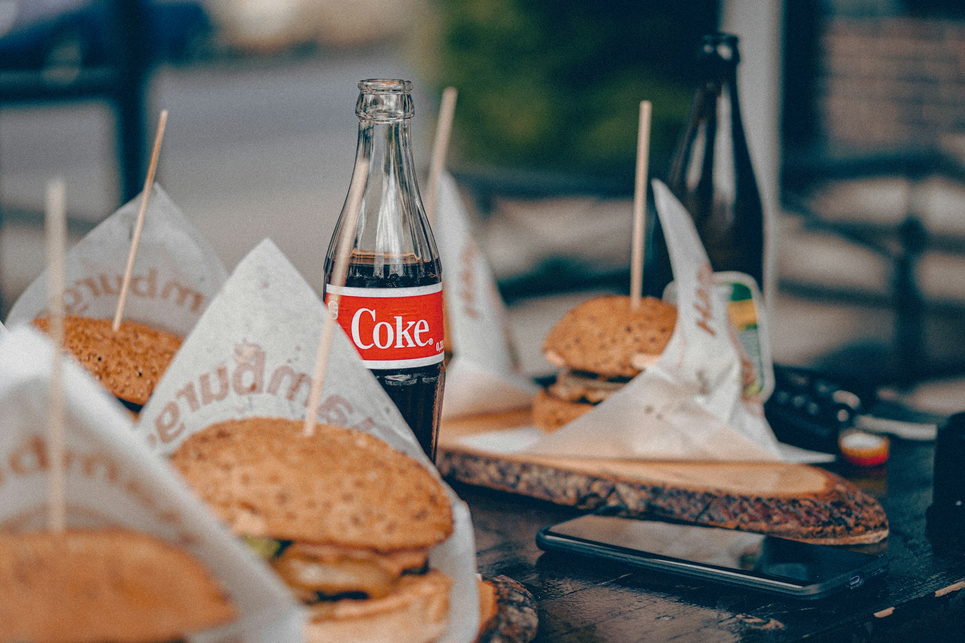 coca cola bottle beside burger and fries on tray