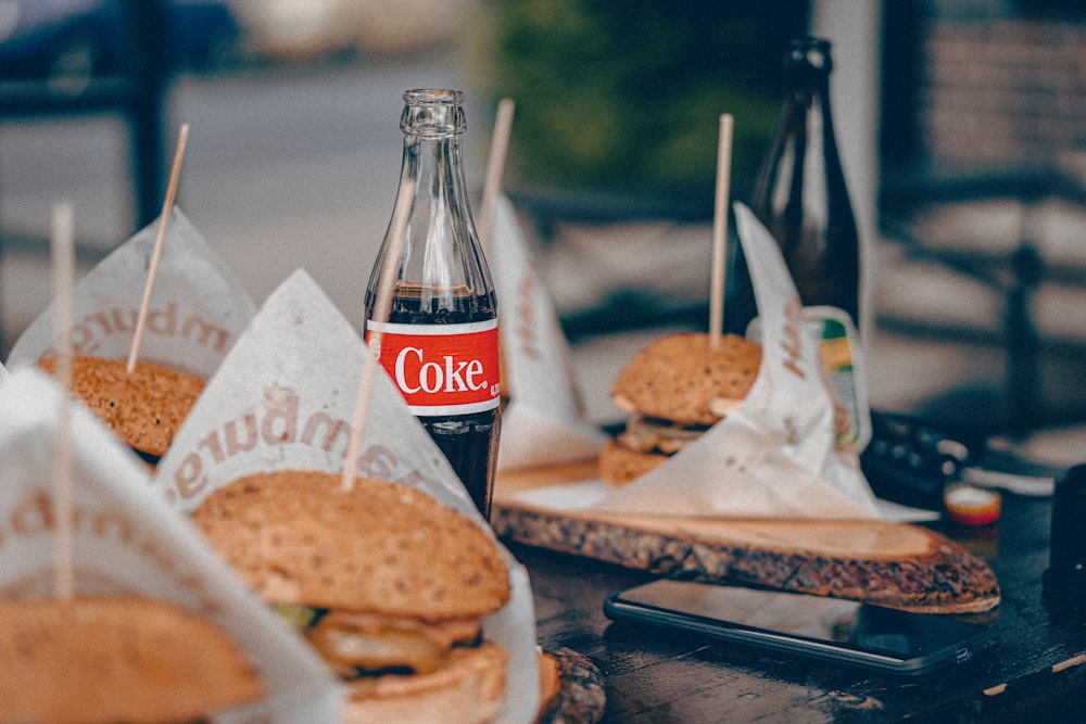 coca cola bottle beside burger and fries on tray