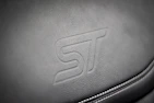 A close-up shot of a leather tag embossed with the Leathers4Riders logo sewn onto a stylish jacket.