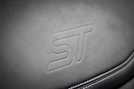 Close-up of embossed leather with a custom logo design.