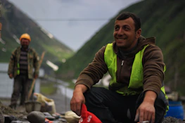 A smiling worker arriving at a nearby location to help with a task found on Zipup.