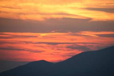 A vibrant sunset over rolling hills.