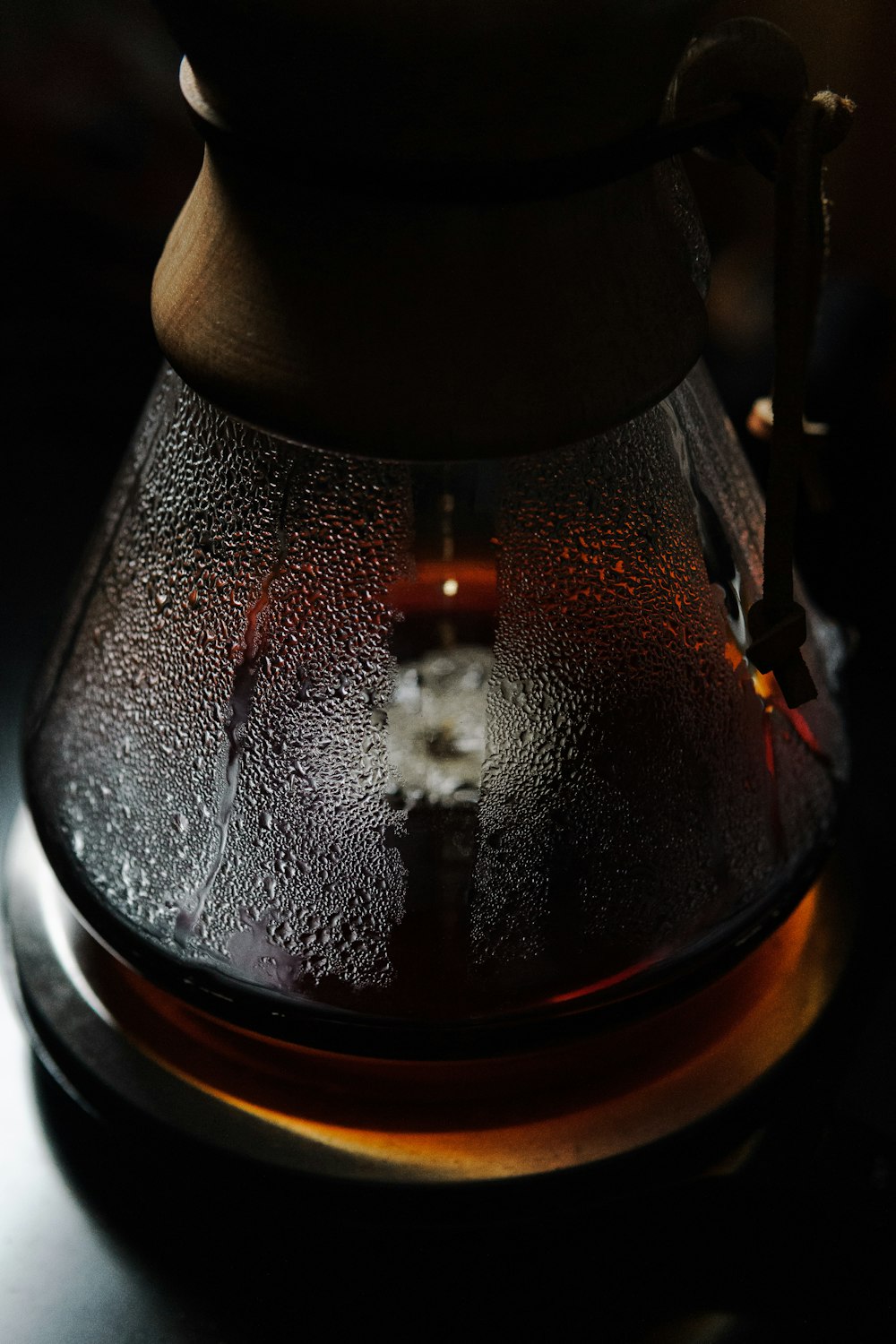 clear glass bottle with brown liquid