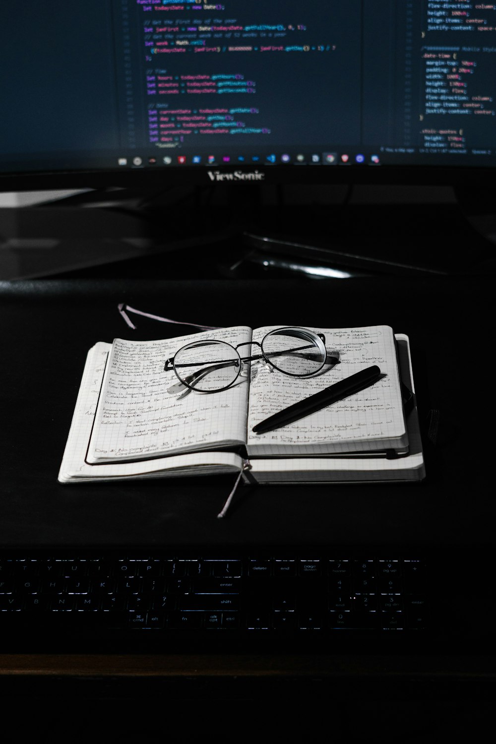 black framed eyeglasses on white paper