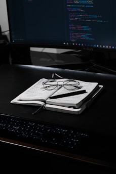black framed eyeglasses on white paper