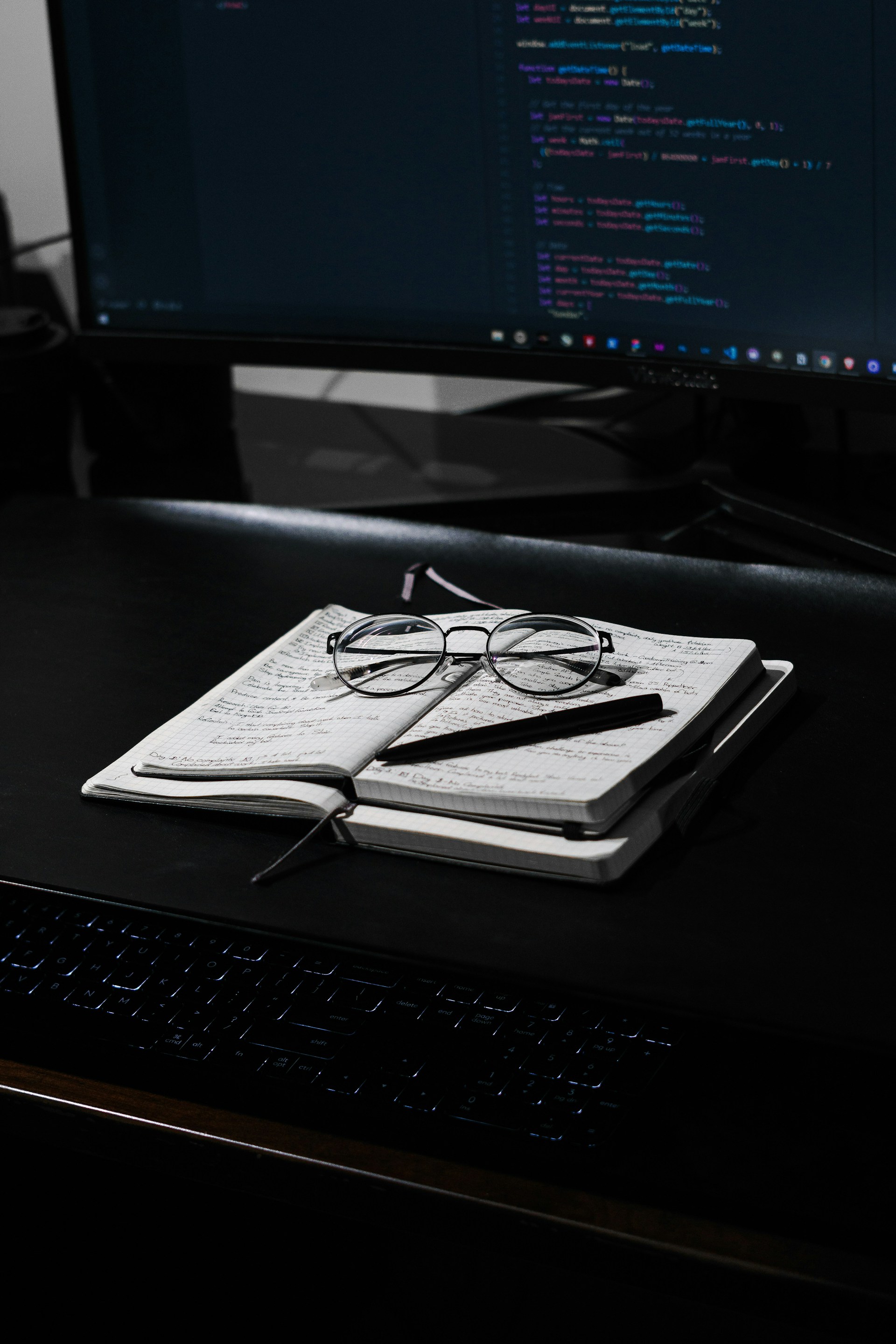 black framed eyeglasses on white paper