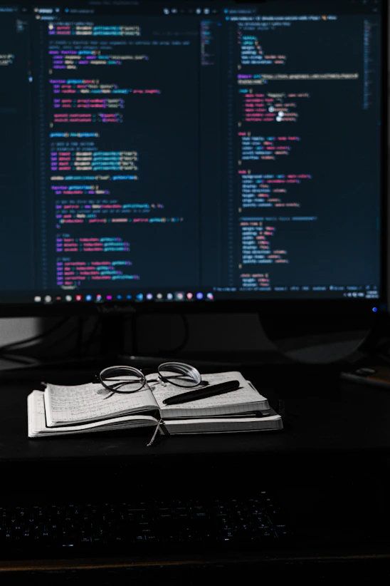 A cozy workspace with a laptop displaying AI tutorials and notes scattered around.