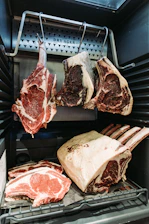 raw meat on black metal grill