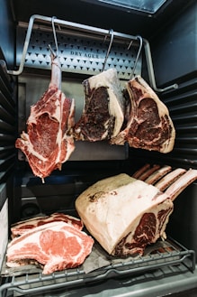 raw meat on black metal grill