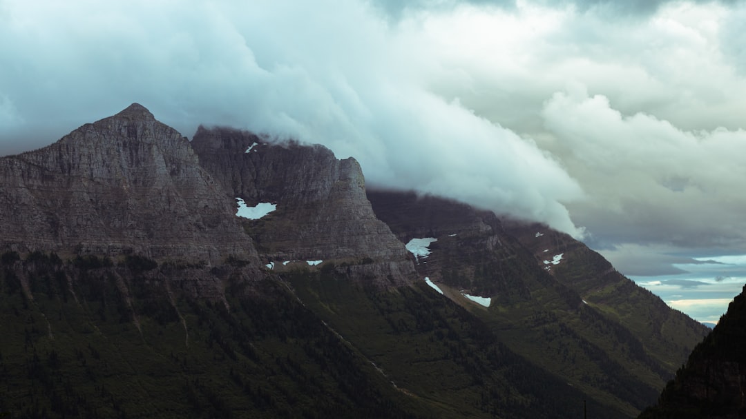 green and brown mountain under white clouds during daytime