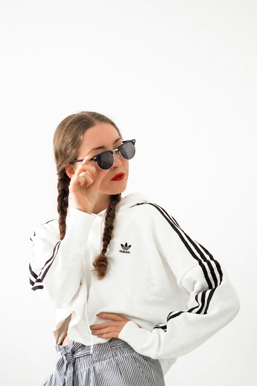 woman in white long sleeve shirt wearing black sunglasses