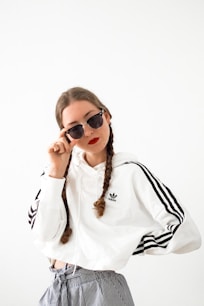 woman in white long sleeve shirt wearing black sunglasses