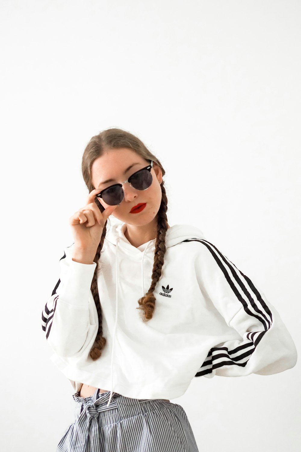 woman in white long sleeve shirt wearing black sunglasses