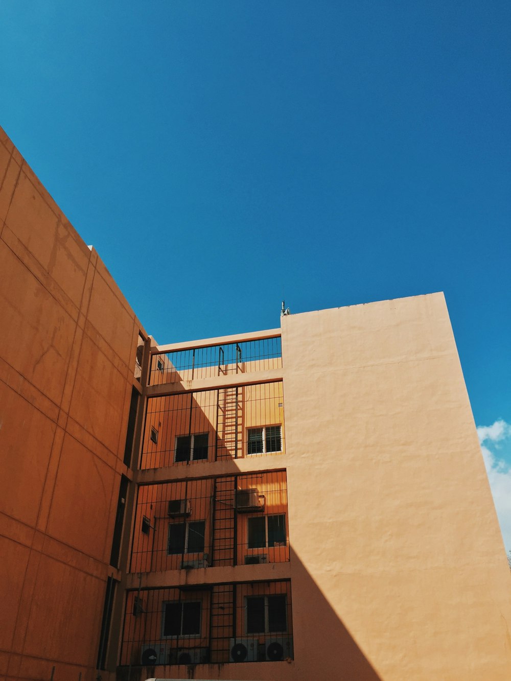 Edificio de hormigón marrón bajo el cielo azul durante el día