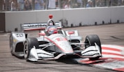 white and red f 1 car on road