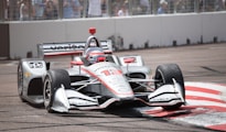 white and red f 1 car on road