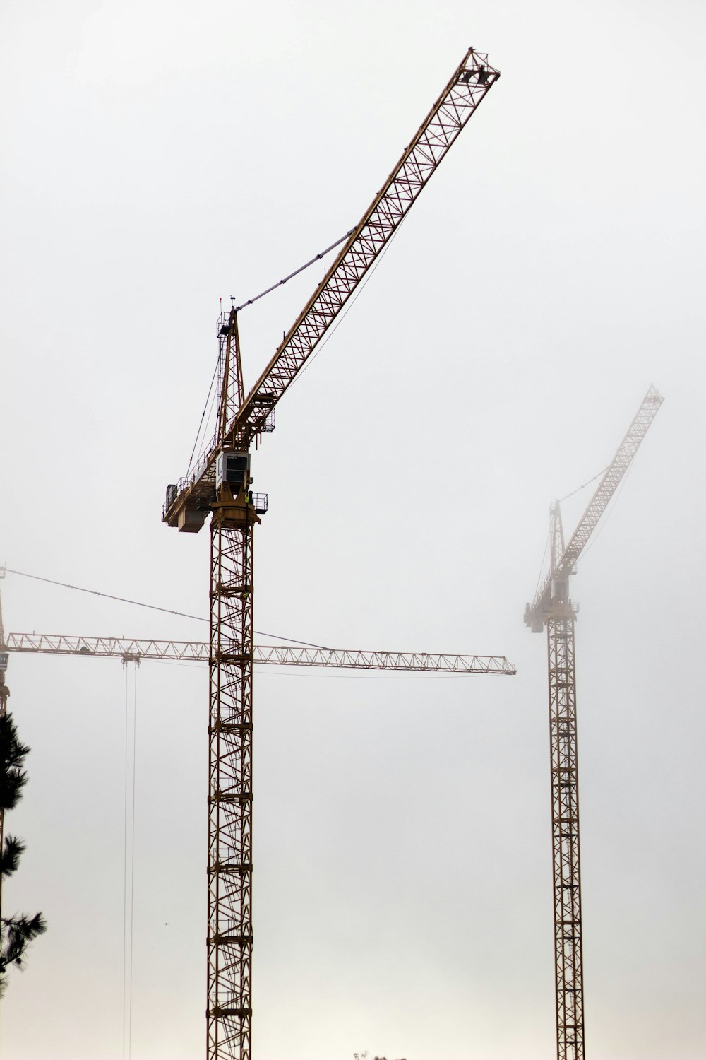 yellow crane under cloudy sky during daytime