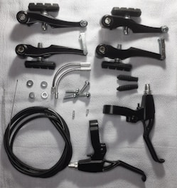 An assortment of brake pads and rotors on a table.