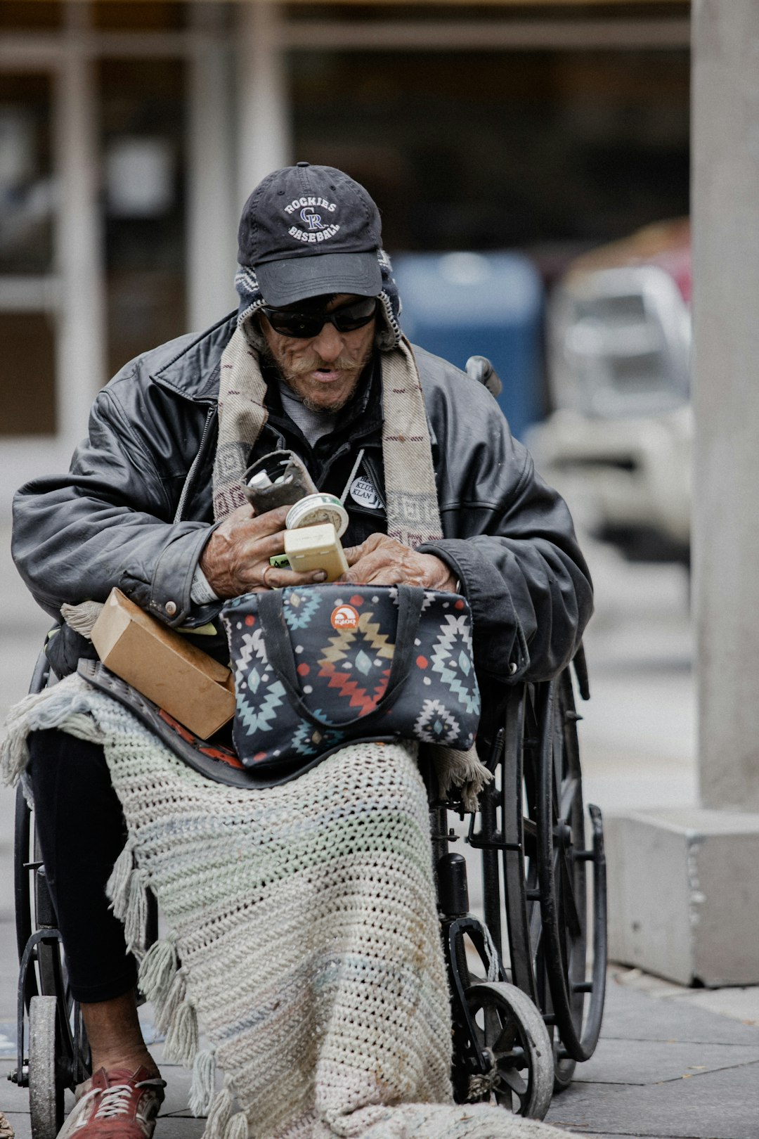 woman in black jacket sitting on black wheel chair