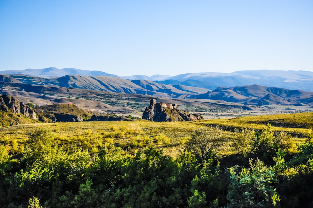 green grass field near mountains during daytime