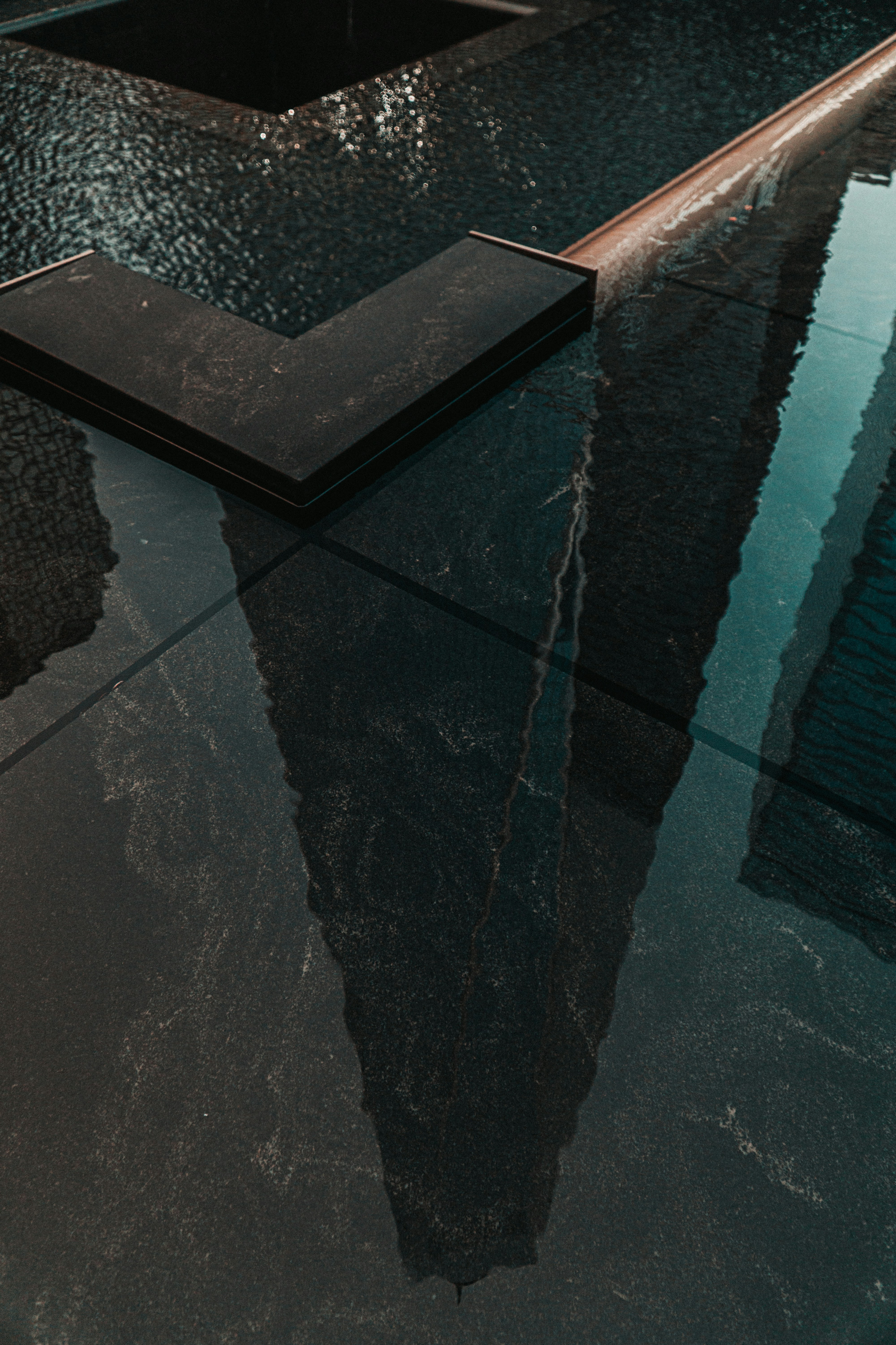black concrete floor near swimming pool