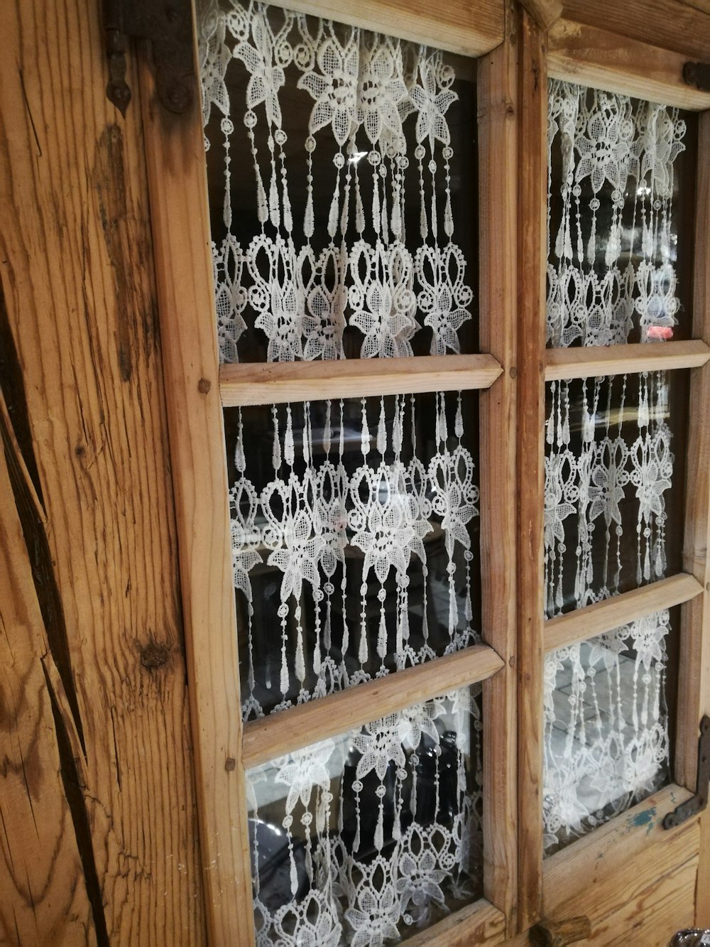 clear glass bottles on brown wooden shelf