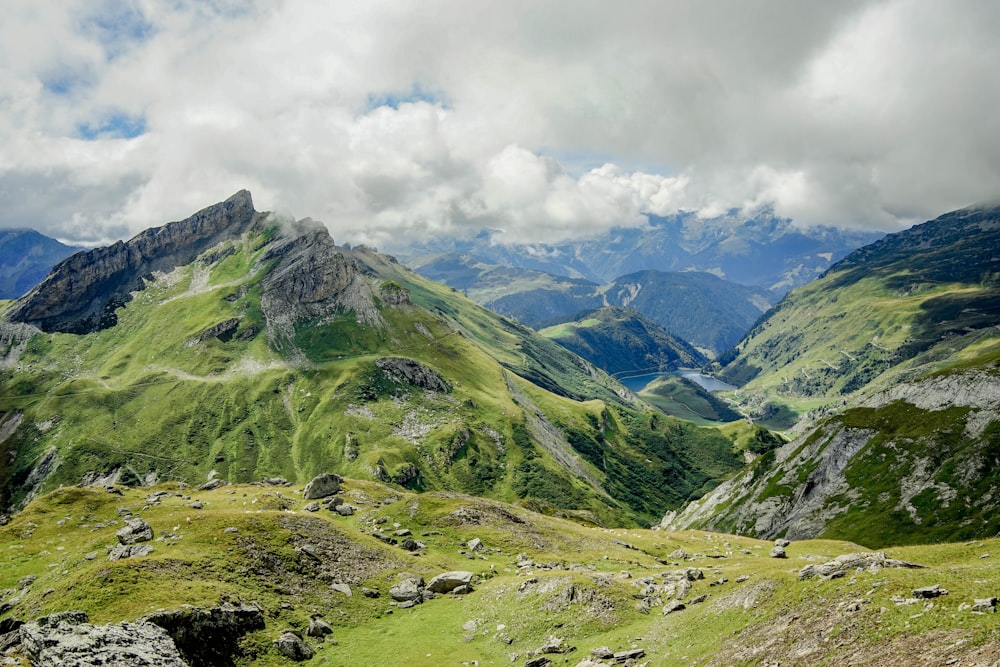 green and white mountains under white clouds during daytime