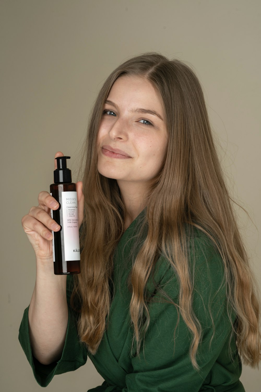 woman holding white and black labeled bottle