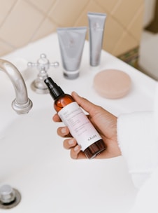 person holding white labeled bottle